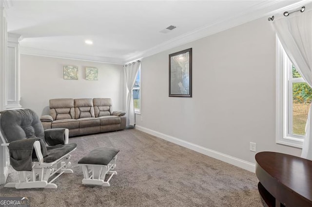 living room with carpet floors, crown molding, and ornate columns