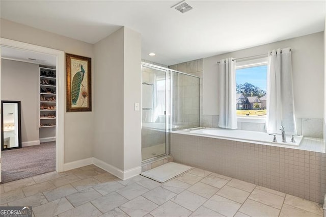 bathroom featuring shower with separate bathtub