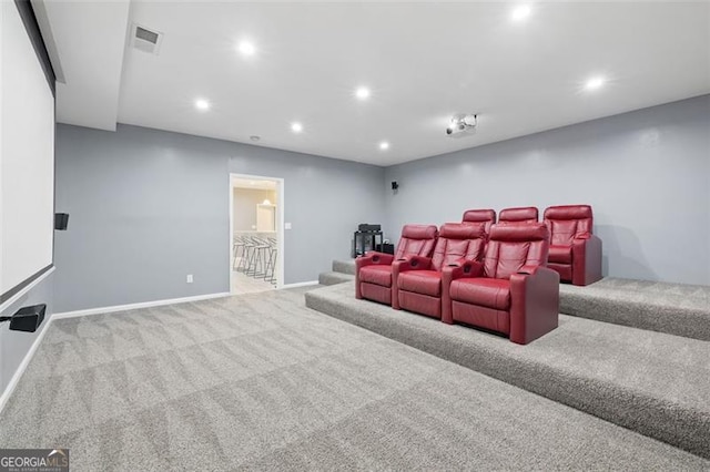 home theater room with light colored carpet