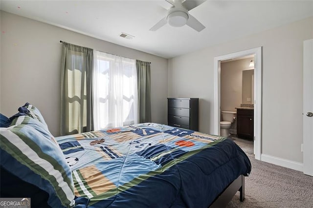 bedroom with carpet flooring, connected bathroom, and ceiling fan