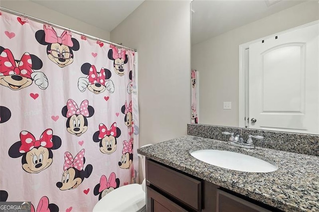 bathroom featuring vanity and toilet