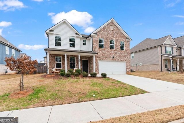 view of front of house featuring covered porch, a garage, and a front yard