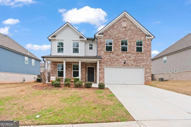 view of front of house with a front yard, a garage, and central AC unit