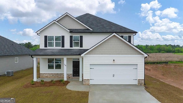 craftsman-style house featuring cooling unit, a garage, and a front lawn