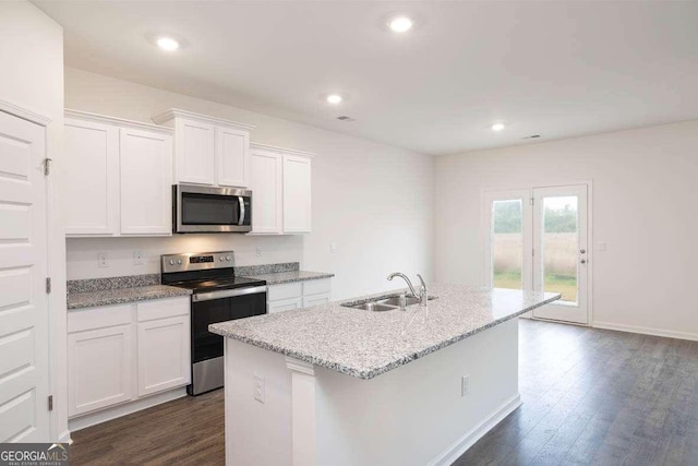 kitchen featuring white cabinetry, sink, dark hardwood / wood-style flooring, a kitchen island with sink, and appliances with stainless steel finishes