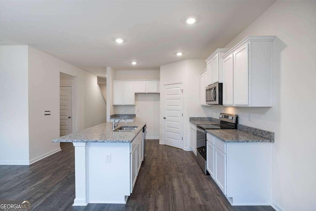 kitchen with stainless steel appliances, white cabinetry, dark hardwood / wood-style floors, and an island with sink