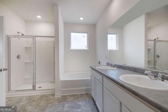 bathroom with shower with separate bathtub and vanity