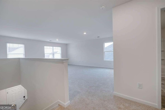 spare room with light colored carpet