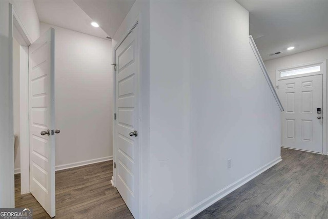 corridor with dark hardwood / wood-style flooring