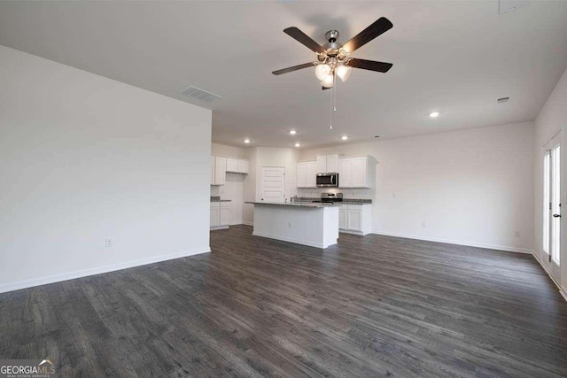 unfurnished living room with dark hardwood / wood-style floors and ceiling fan