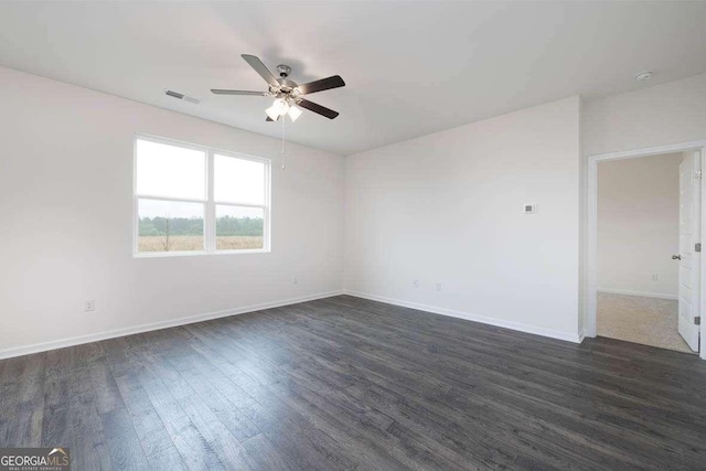 empty room featuring ceiling fan and dark hardwood / wood-style flooring