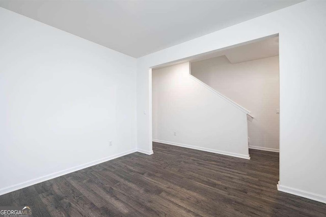 empty room with dark wood-type flooring