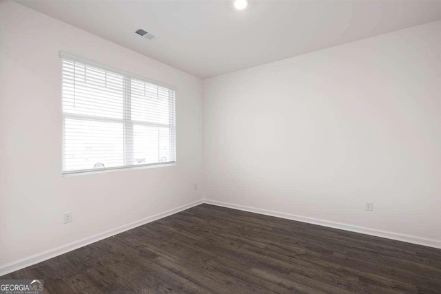 unfurnished room featuring dark hardwood / wood-style floors