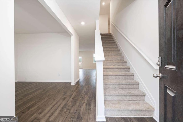 staircase with wood-type flooring