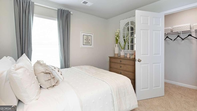 bedroom featuring a closet and light colored carpet