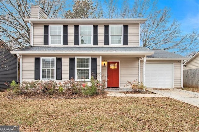 front facade with a front yard and a garage