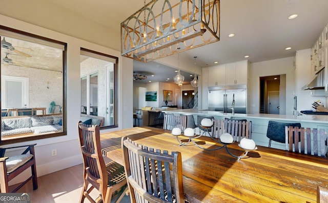 dining space featuring ceiling fan and light hardwood / wood-style flooring