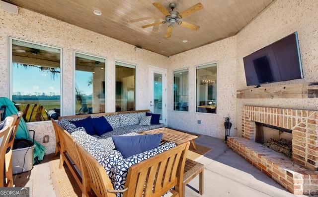 view of patio / terrace featuring an outdoor living space with a fireplace and ceiling fan