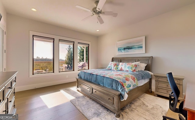 bedroom with light hardwood / wood-style floors and ceiling fan