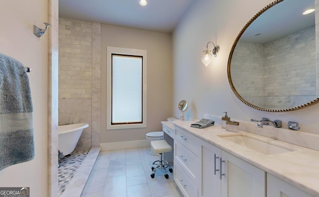 bathroom with a bathing tub, tile patterned flooring, toilet, and vanity