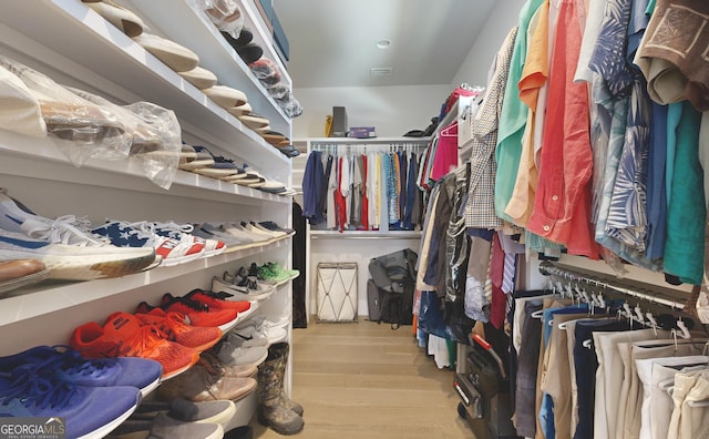 spacious closet with light hardwood / wood-style floors