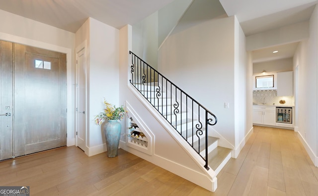 stairway with hardwood / wood-style flooring