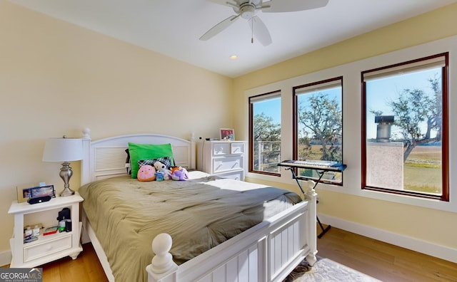 bedroom with hardwood / wood-style floors and ceiling fan