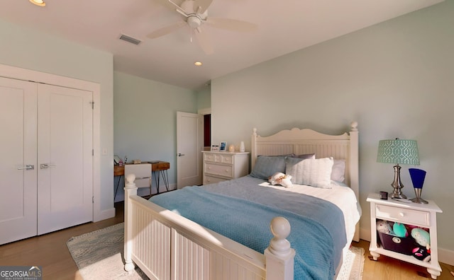 bedroom with a closet, ceiling fan, and hardwood / wood-style floors