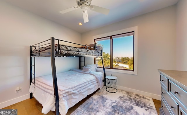 bedroom with ceiling fan and light hardwood / wood-style floors