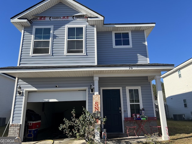 view of front of home featuring a garage and central AC