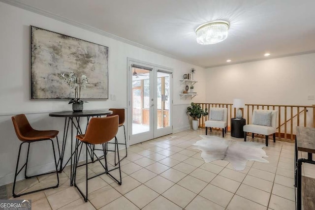 living area featuring french doors, crown molding, and light tile patterned flooring