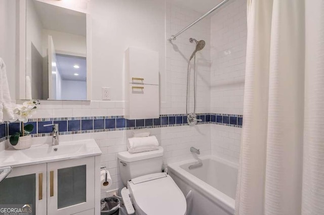 full bathroom featuring vanity, toilet, shower / bathtub combination with curtain, and tile walls