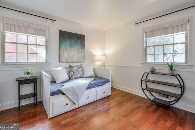 sitting room featuring hardwood / wood-style flooring and crown molding