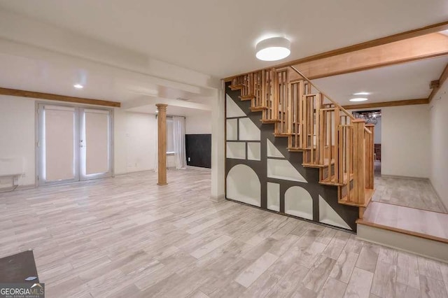 basement with light hardwood / wood-style flooring