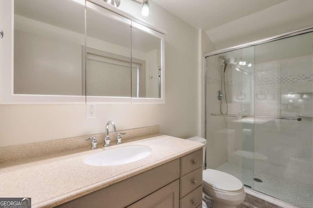 bathroom featuring vanity, toilet, and walk in shower