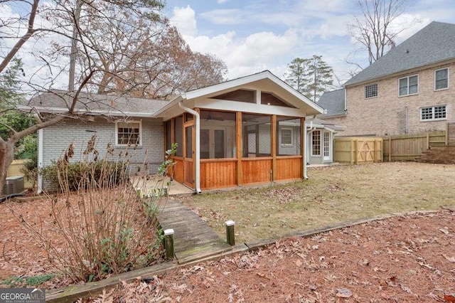 view of front of house featuring a sunroom and cooling unit