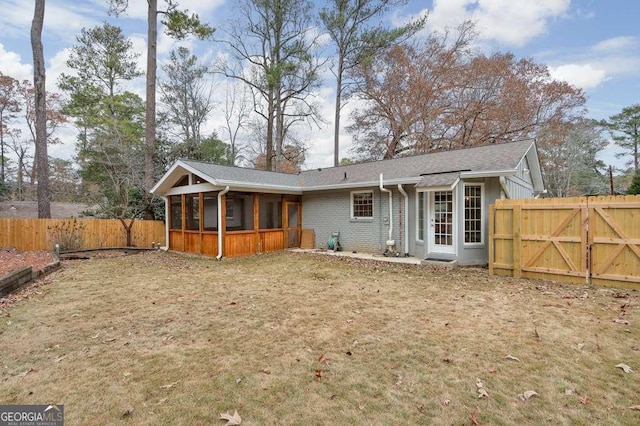 rear view of property featuring a sunroom