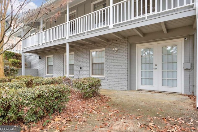 entrance to property with french doors and a balcony