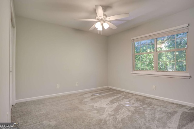 unfurnished room with ceiling fan and carpet floors