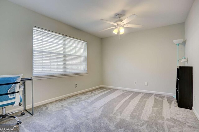 office area with ceiling fan and light carpet