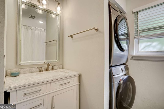 bathroom with curtained shower, vanity, and stacked washer and clothes dryer