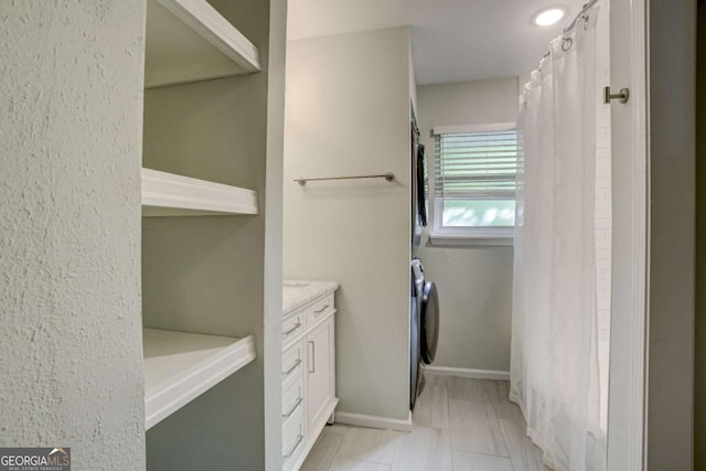 bathroom with washer / dryer and vanity