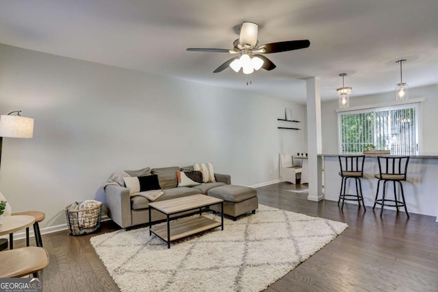 living room with ceiling fan and dark hardwood / wood-style flooring