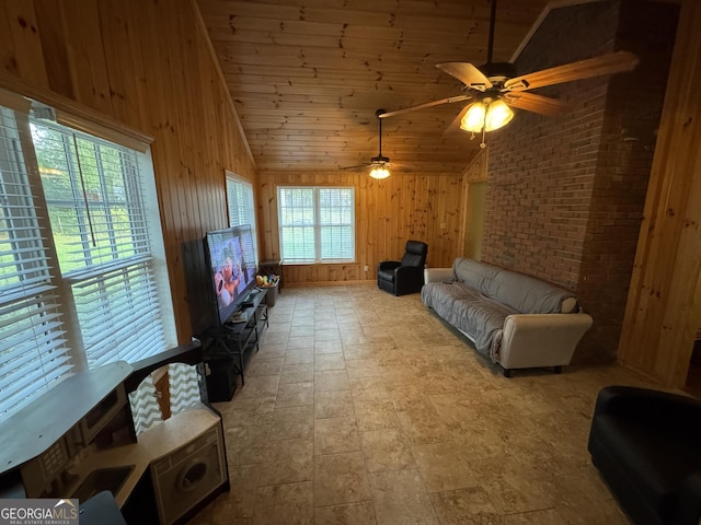 living area with brick wall, wood walls, lofted ceiling, wooden ceiling, and a ceiling fan