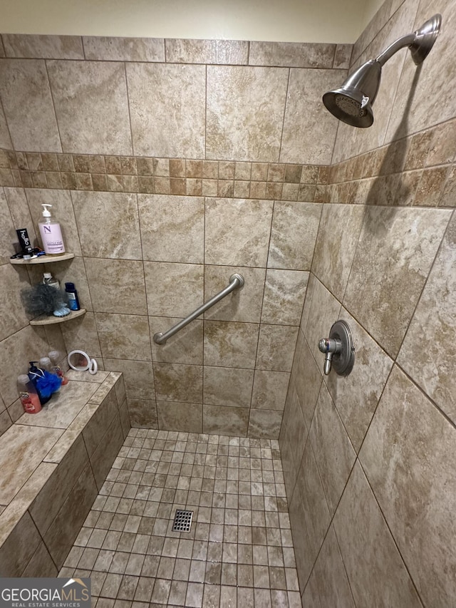 bathroom with tiled shower