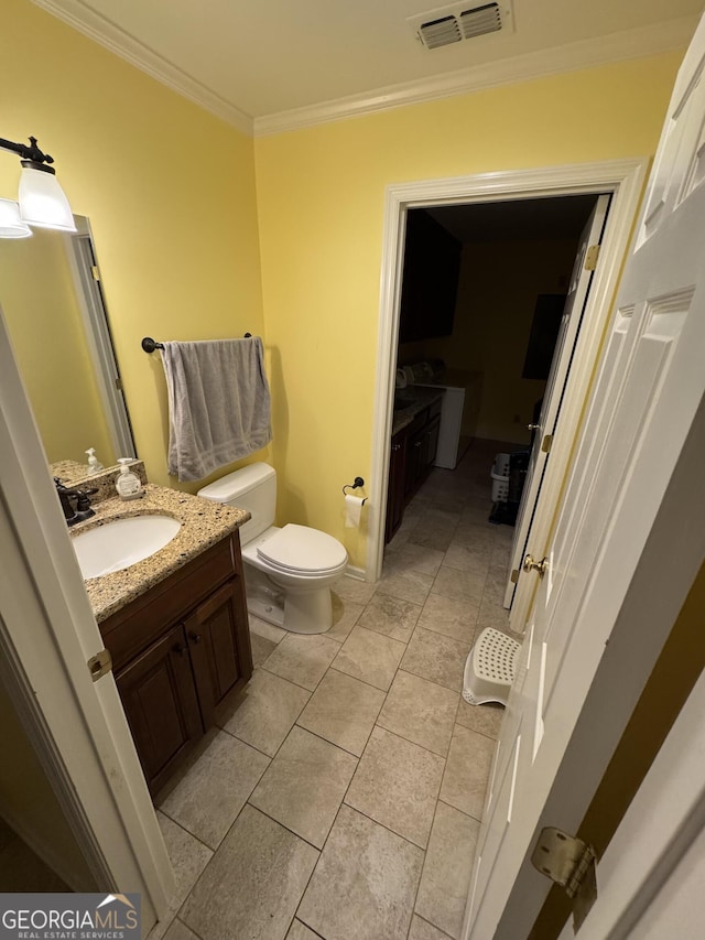 bathroom featuring vanity, visible vents, ornamental molding, tile patterned flooring, and toilet