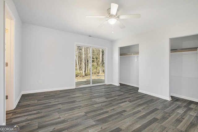 unfurnished bedroom featuring access to outside, multiple closets, ceiling fan, and dark hardwood / wood-style floors