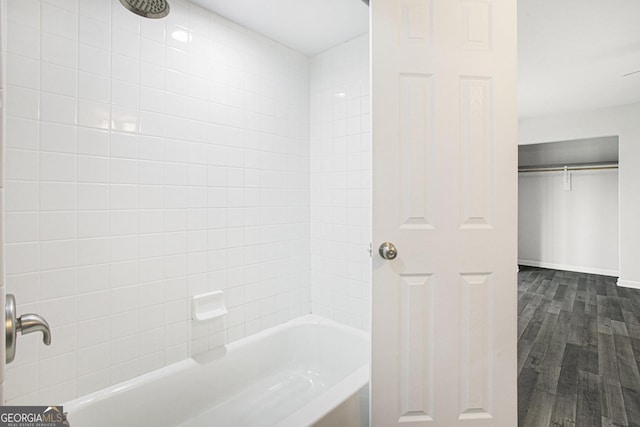 bathroom featuring hardwood / wood-style flooring and tiled shower / bath combo