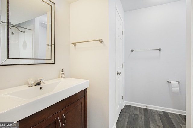 bathroom featuring hardwood / wood-style flooring and vanity