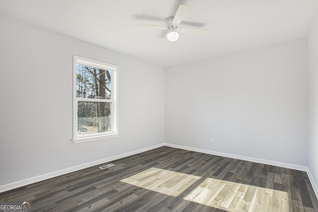 empty room with dark hardwood / wood-style floors and ceiling fan